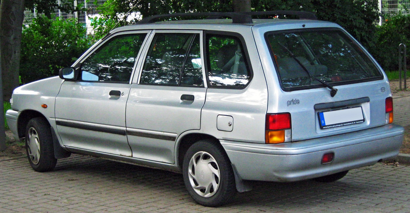 Silver compact station wagon rear side view with roof rails and rear window wiper