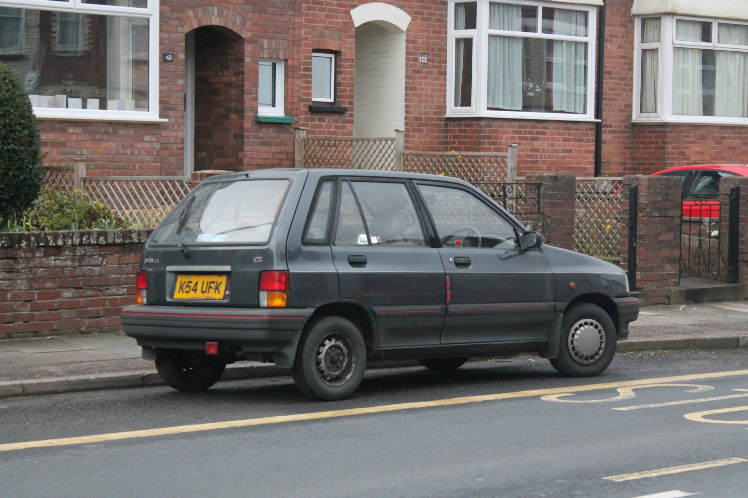 Rear side view of 1990s four-door hatchback with compact design