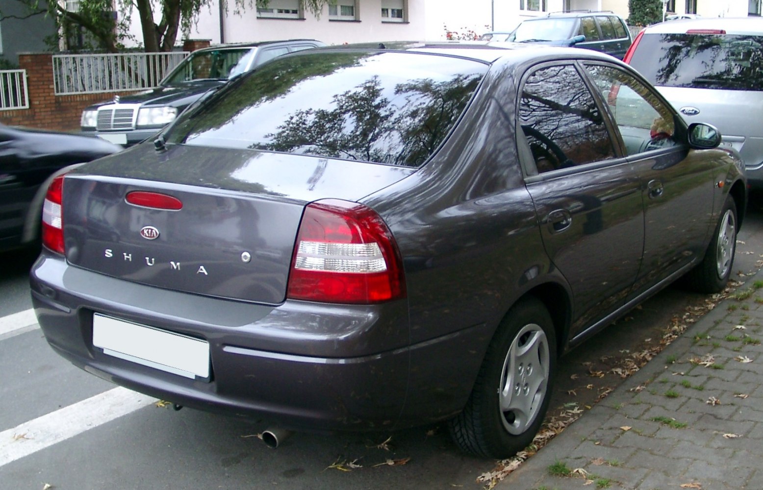 Rear view of sedan showing tail lights, trunk, and side profile