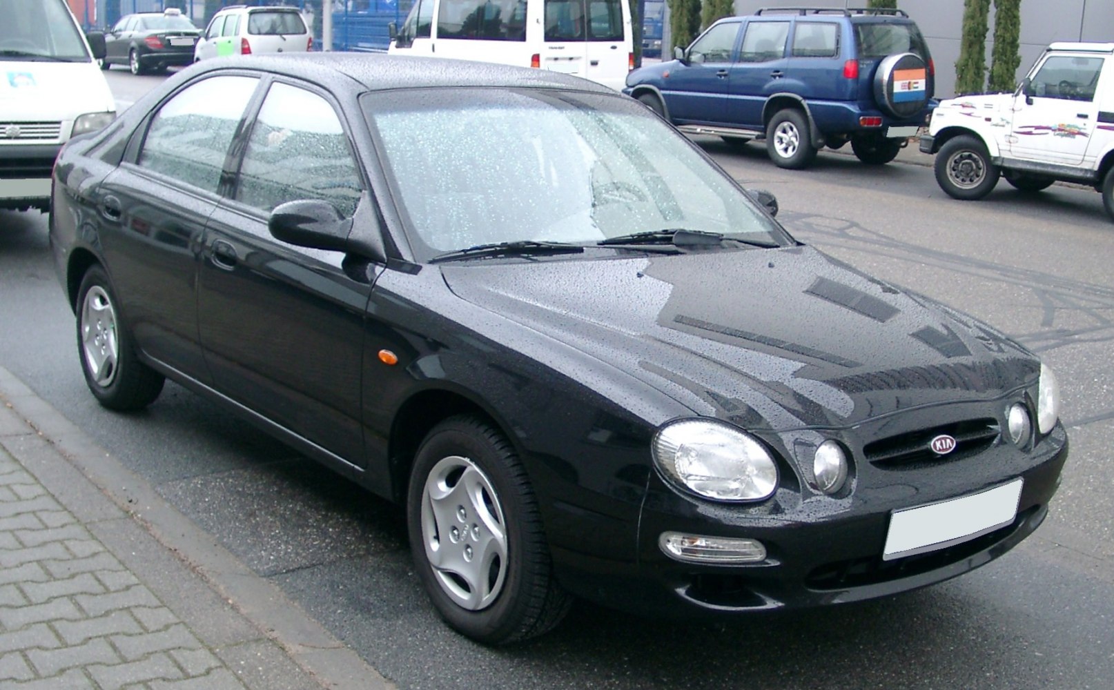 Double oval front headlights on black four-door sedan