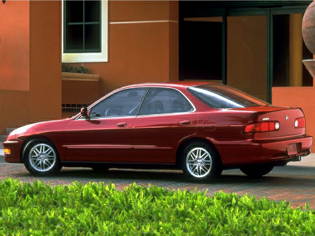 Side profile of a mid-90s sedan with alloy wheels.