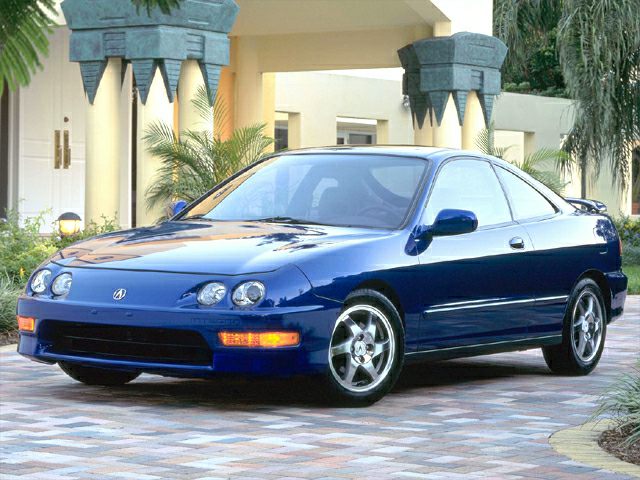 Quad round headlights and alloy wheels on a sleek coupe body