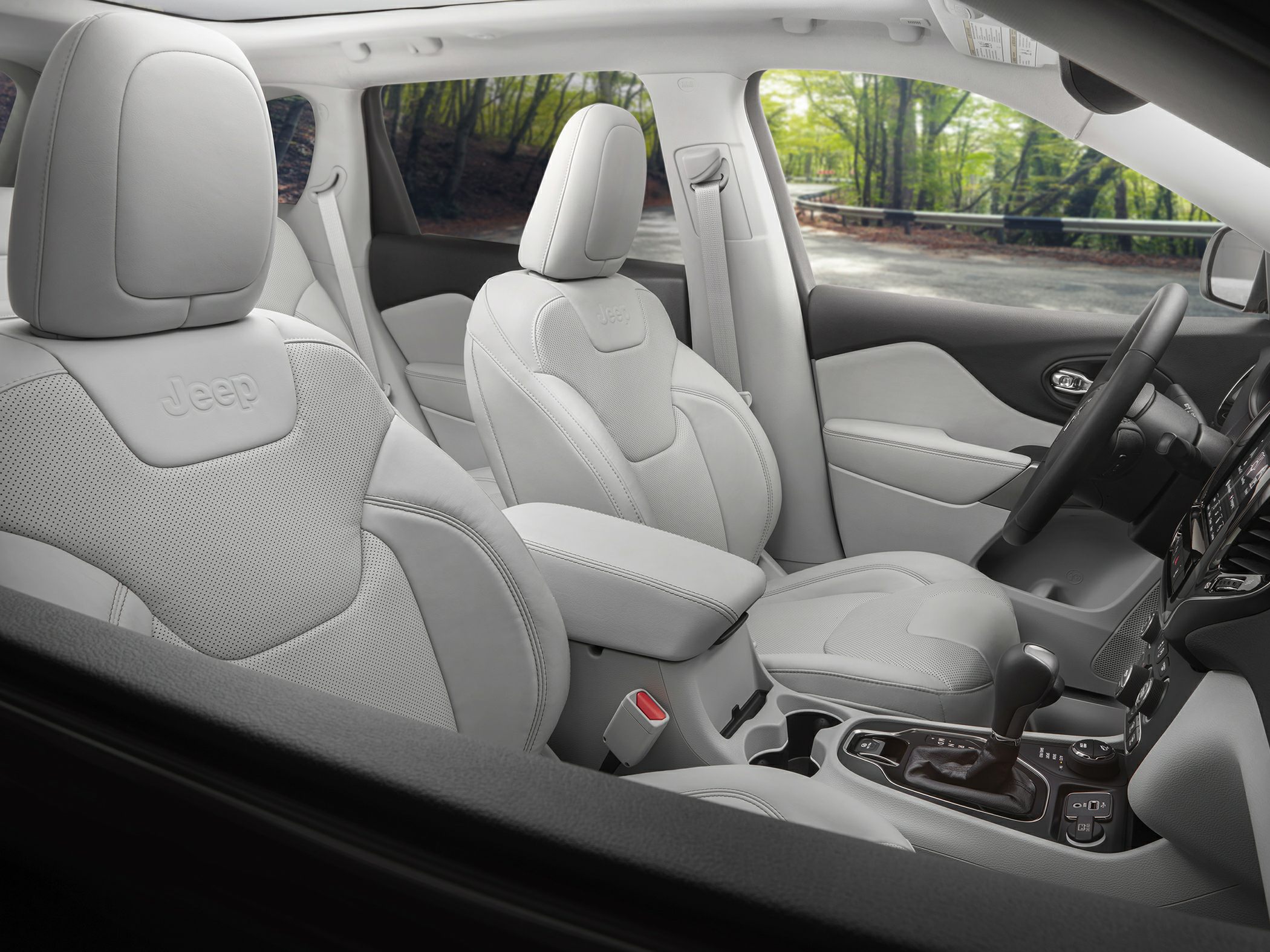White leather seats and modern center console with gear shifter
