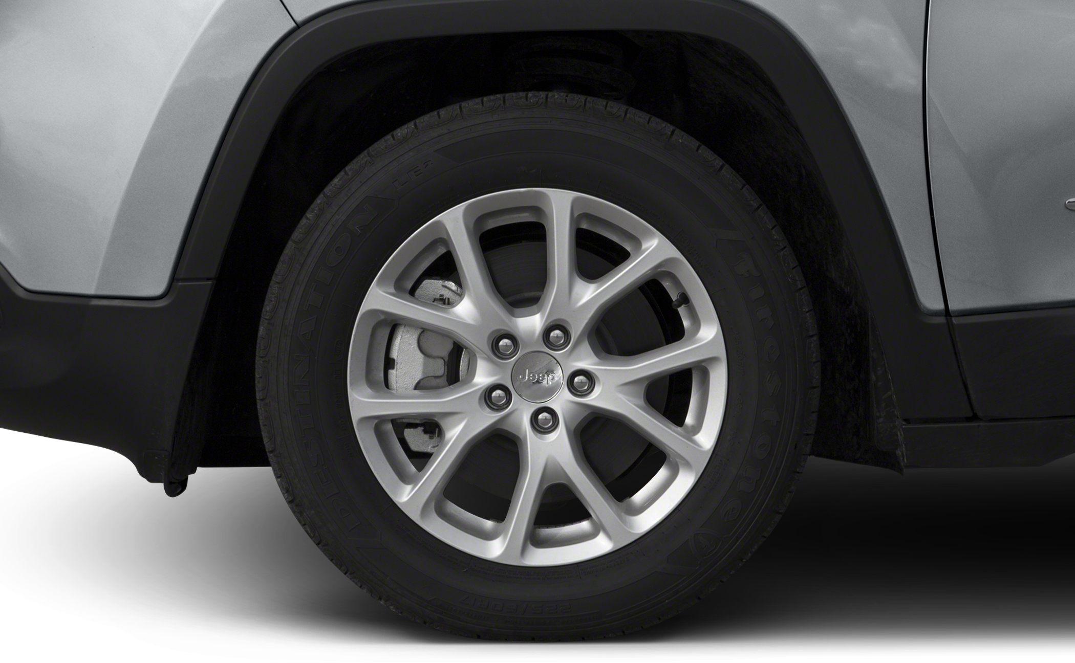 Close-up of alloy wheel and Firestone tire with brake caliper.