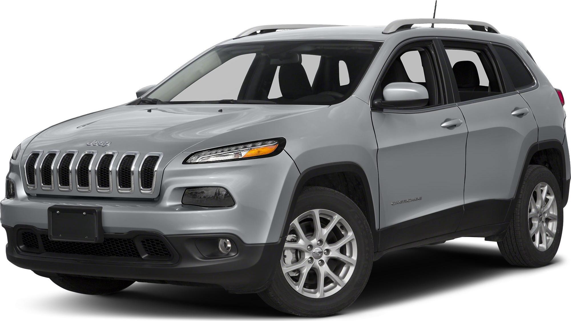 Front 3-4 angled view of silver SUV with seven-slot grille and roof rails