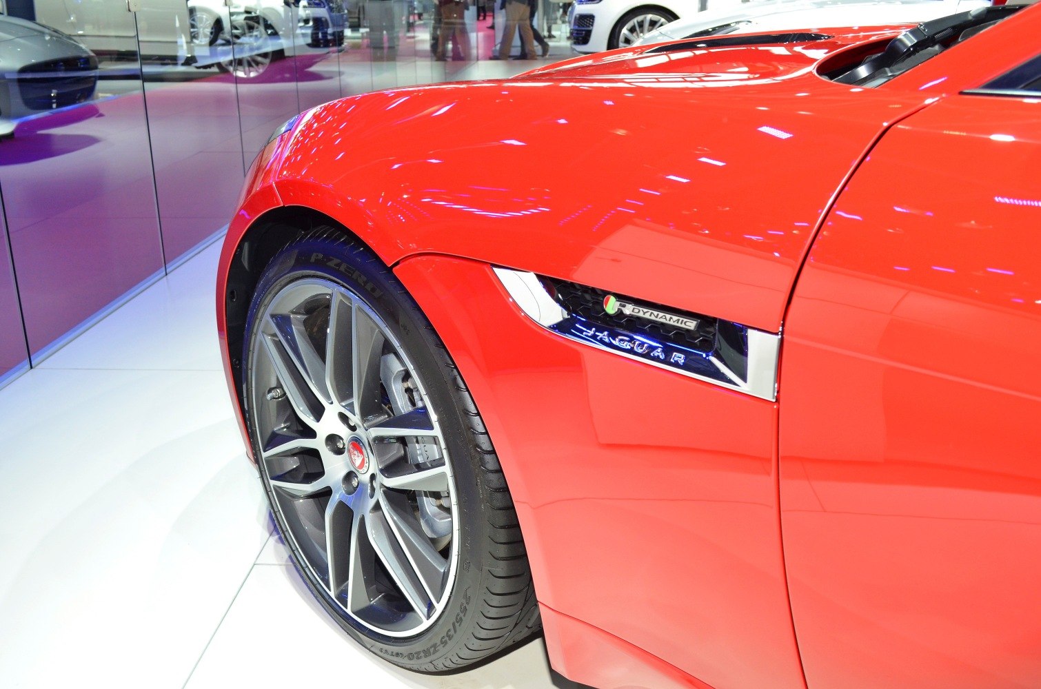 Front alloy wheel and side vent with R-Dynamic badge on red sporty coupe