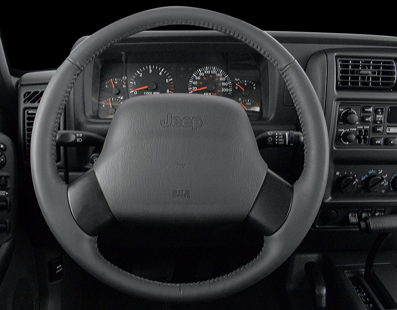 Steering wheel and instrument cluster with dashboard controls.