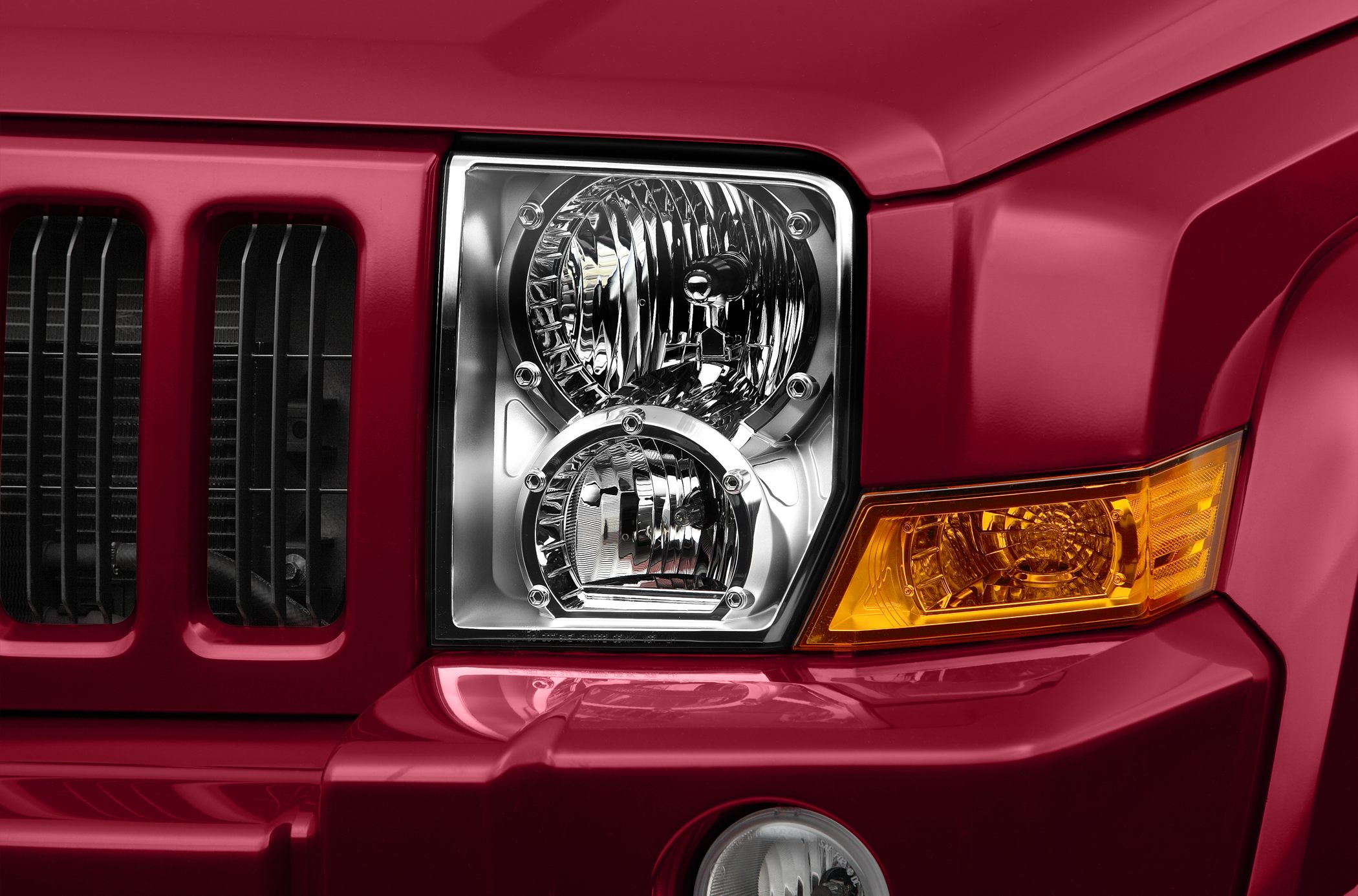 Close-up of headlight and front grille with amber turn signal