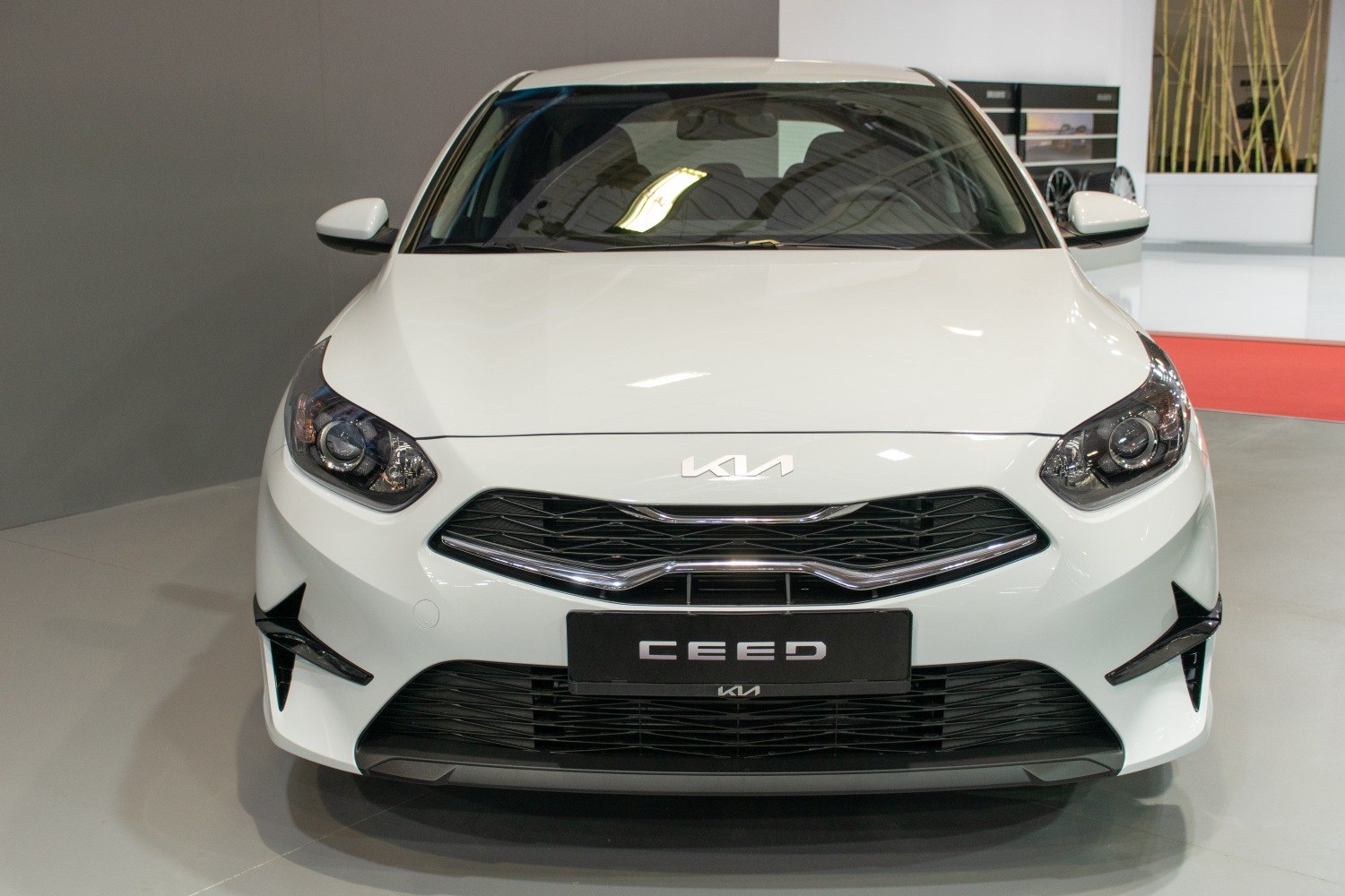 Front grille and headlights of a modern white vehicle