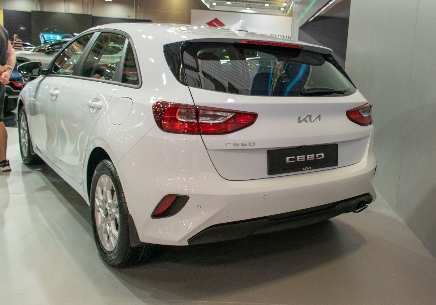 Rear view of a white compact hatchback with LED tail lights and rear spoiler
