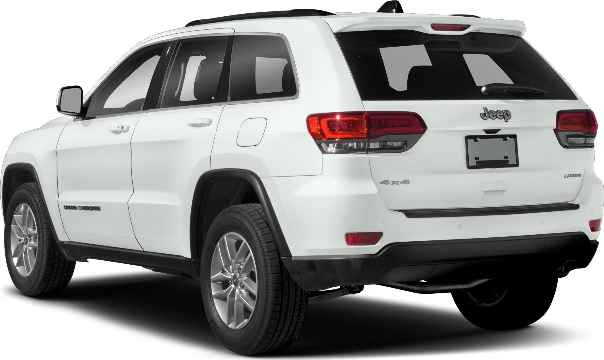 Rear-side view of white SUV with 4x4 and Laredo badges