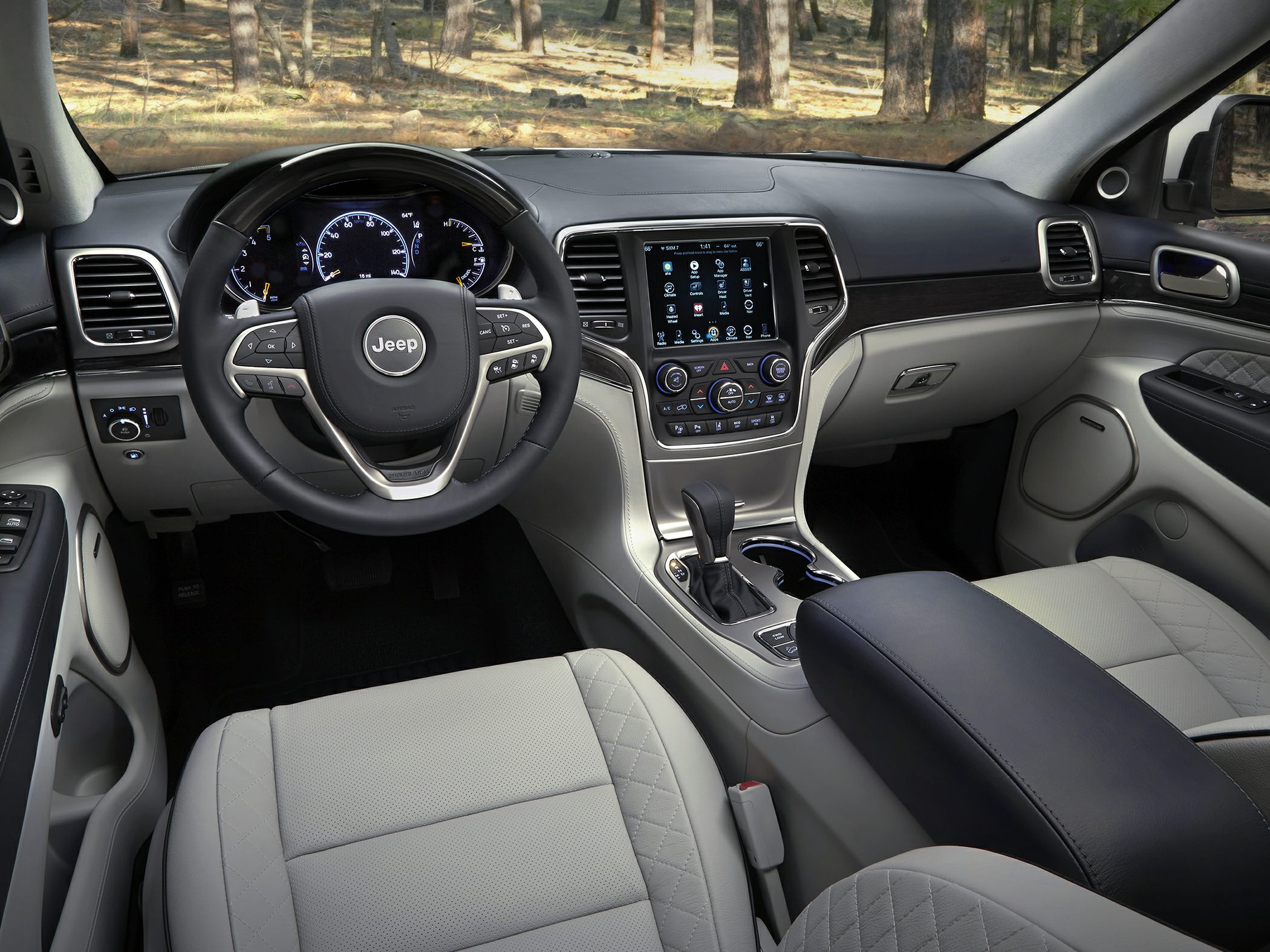 Dashboard, steering wheel, and touchscreen center console in luxury SUV interior