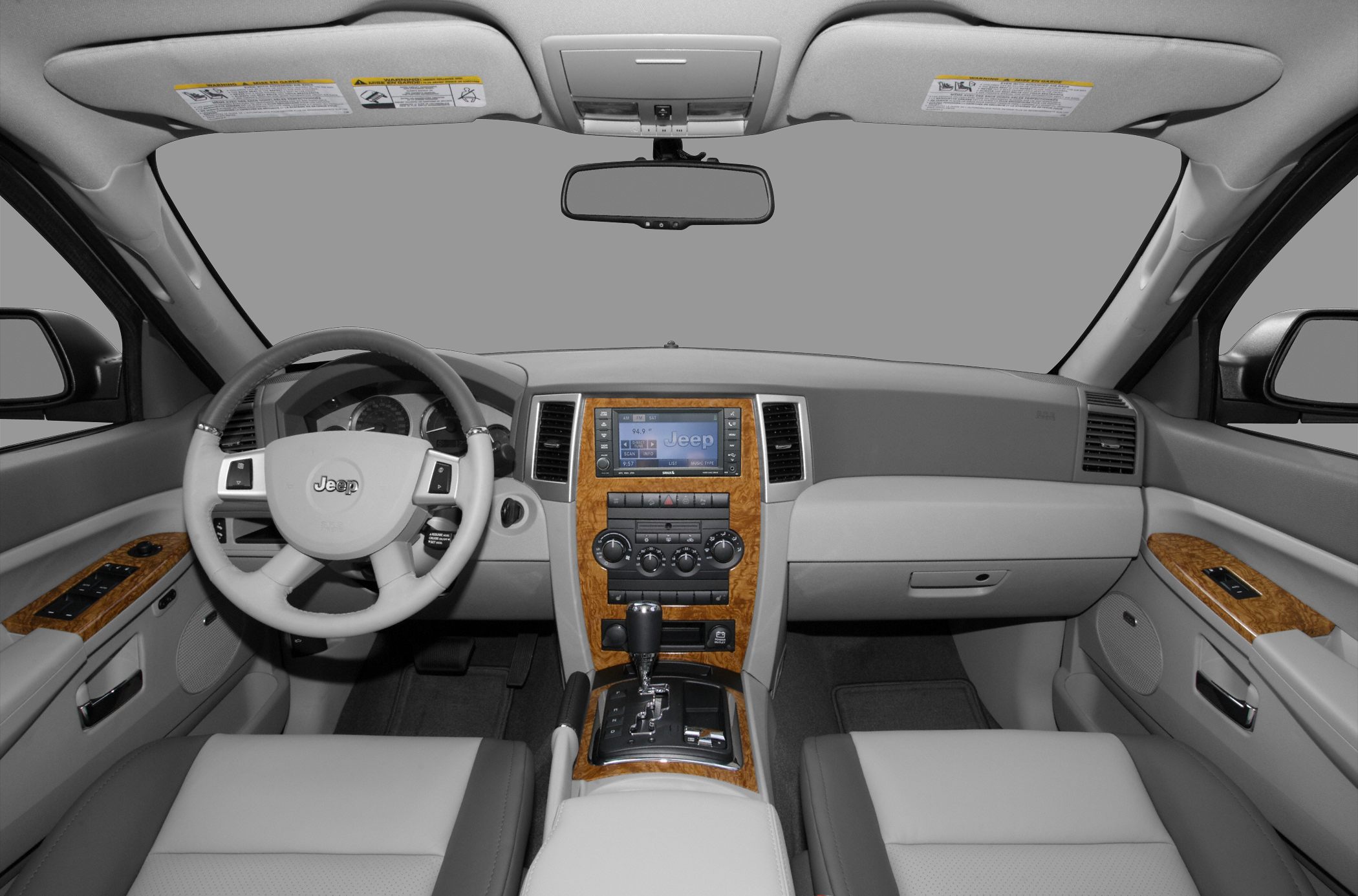 Wood-trimmed dashboard and center console with steering wheel and automatic gear shifter