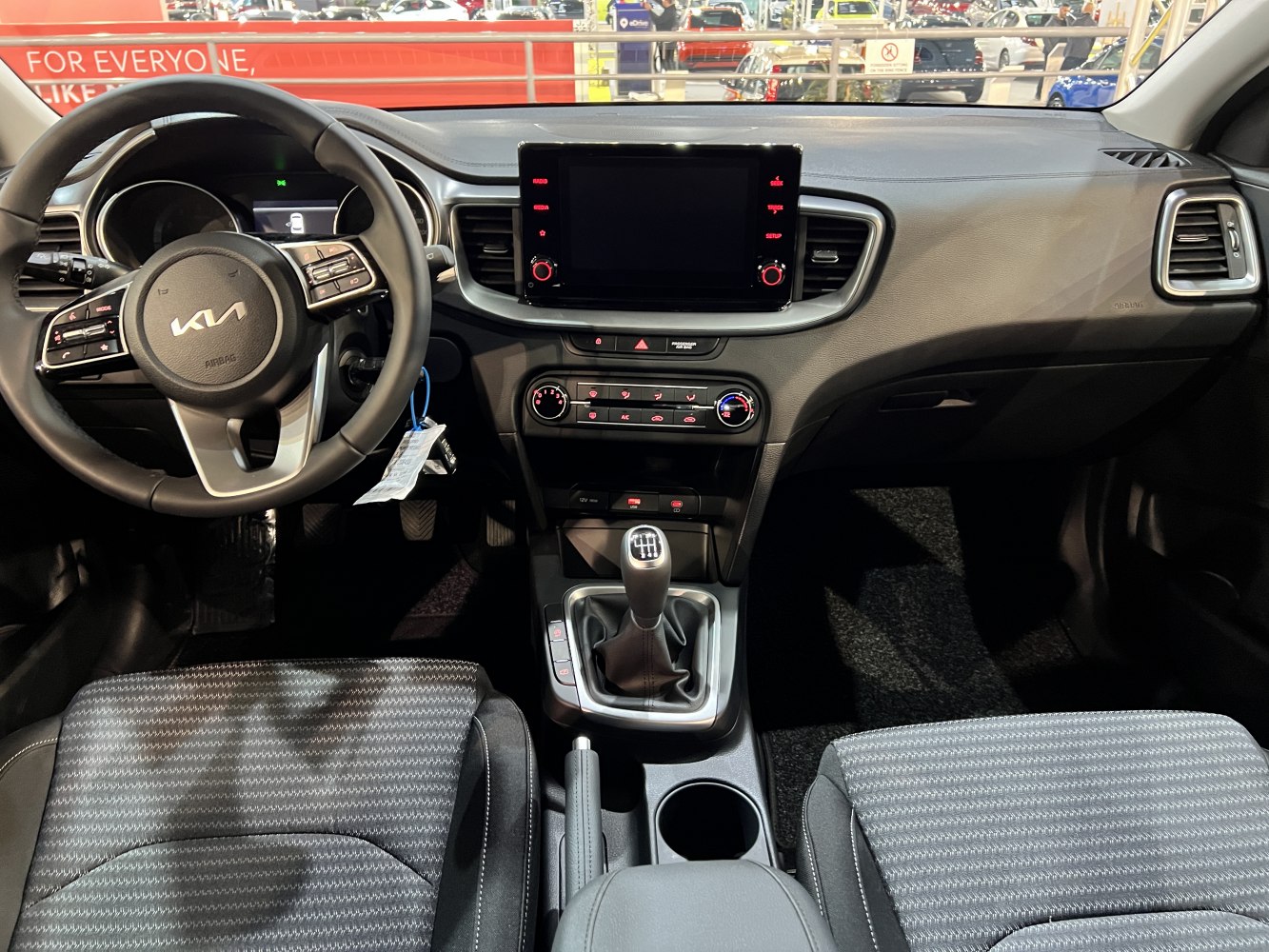 Manual gear shifter, touchscreen infotainment, steering wheel controls