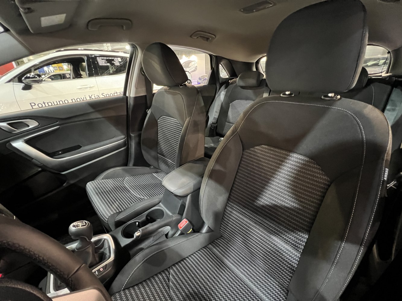 Front interior showing fabric seats and manual gear shifter