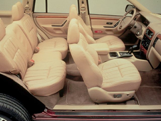 Tan leather interior seats with spacious cabin layout and automatic gear shift
