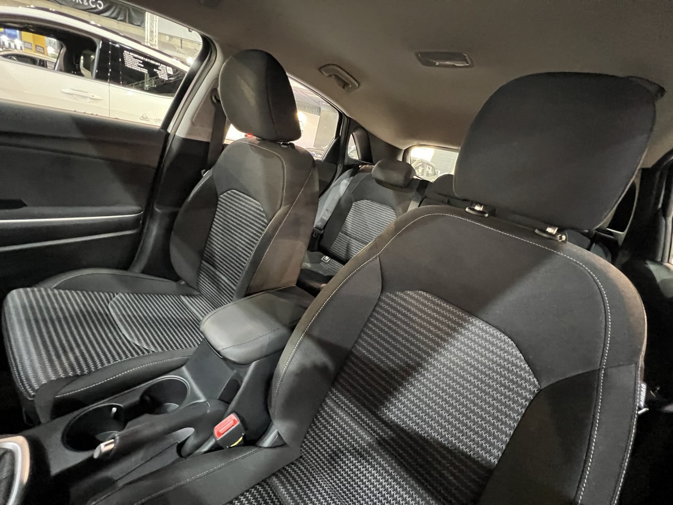 Fabric seats with detailed stitching and front cup holders