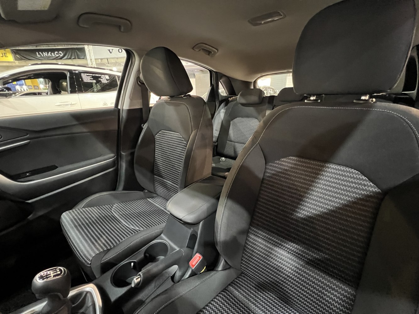Fabric seats and manual transmission inside a compact car cabin