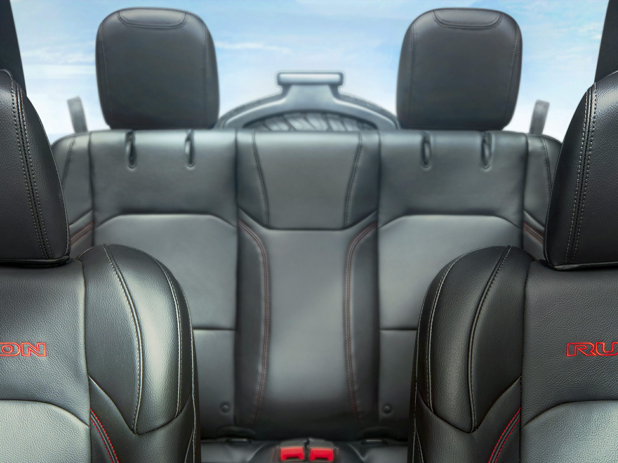 Premium black leather car seats with red stitching and logo embroidery