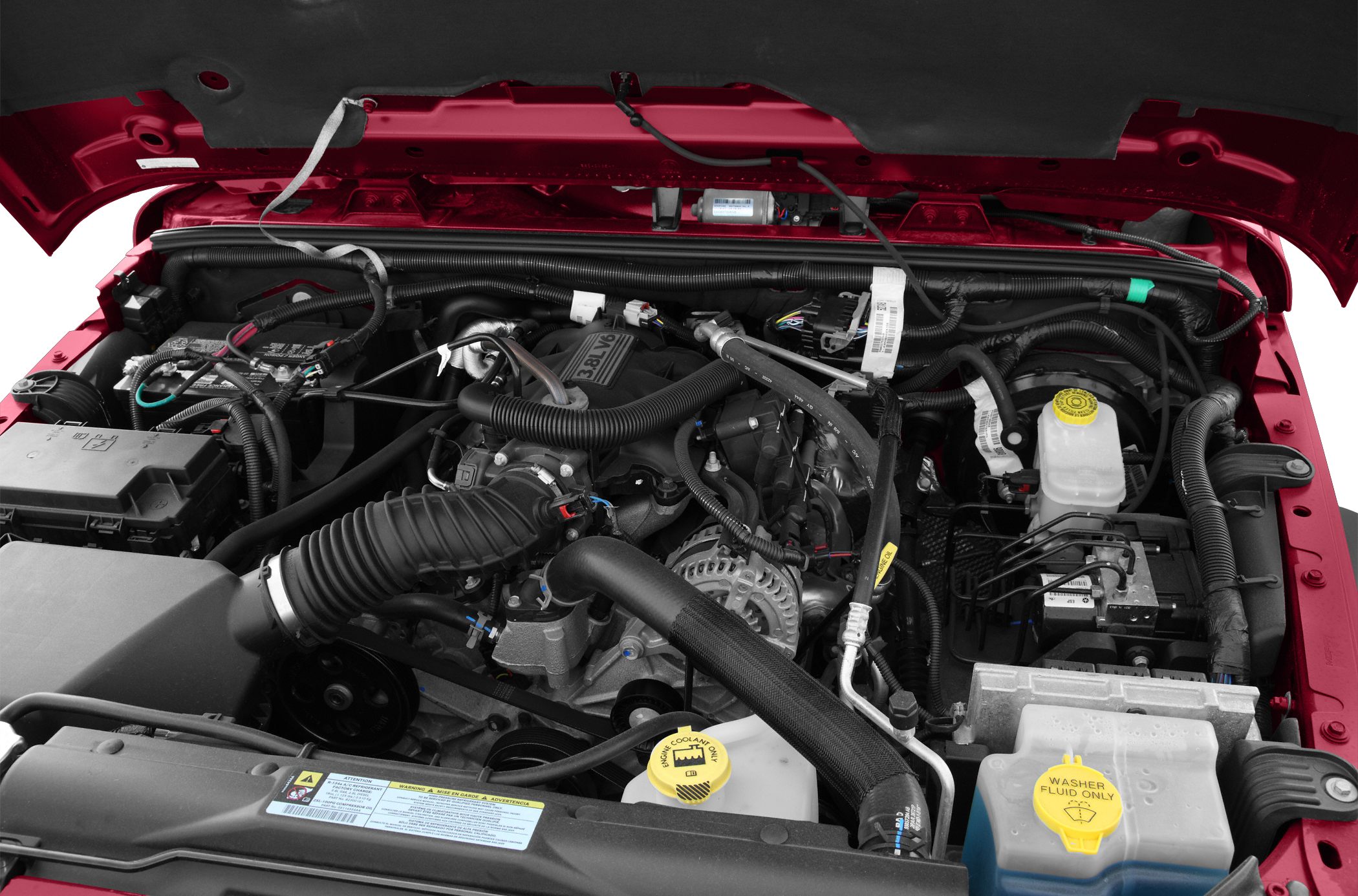 3.8L V6 engine bay with fluid reservoirs and air intake hose