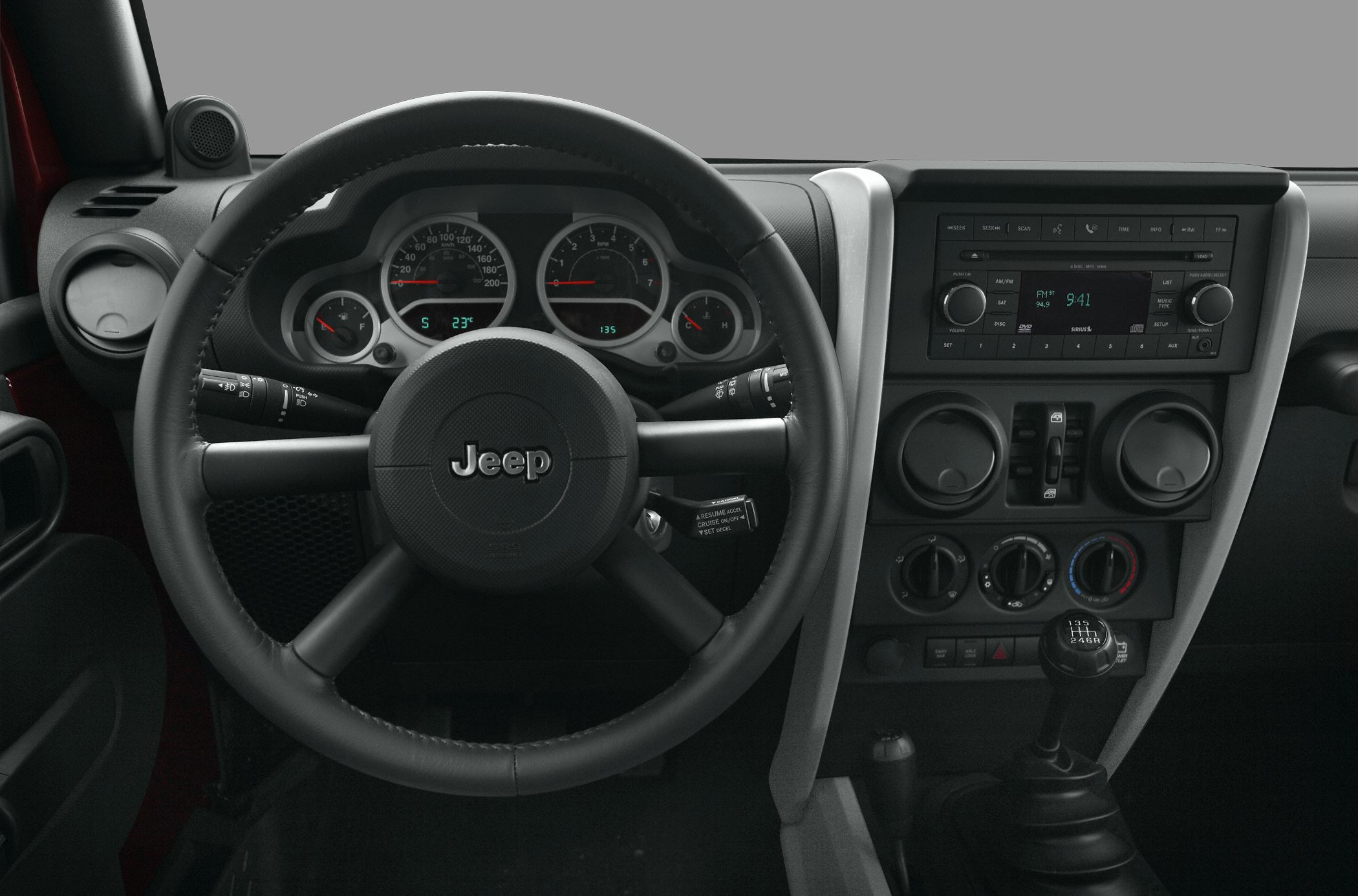 Steering wheel, dashboard, and manual gear shift details.