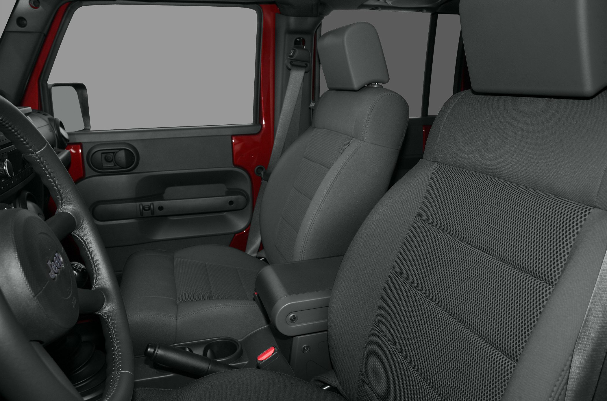 Interior view of front seats, door panel, and steering wheel