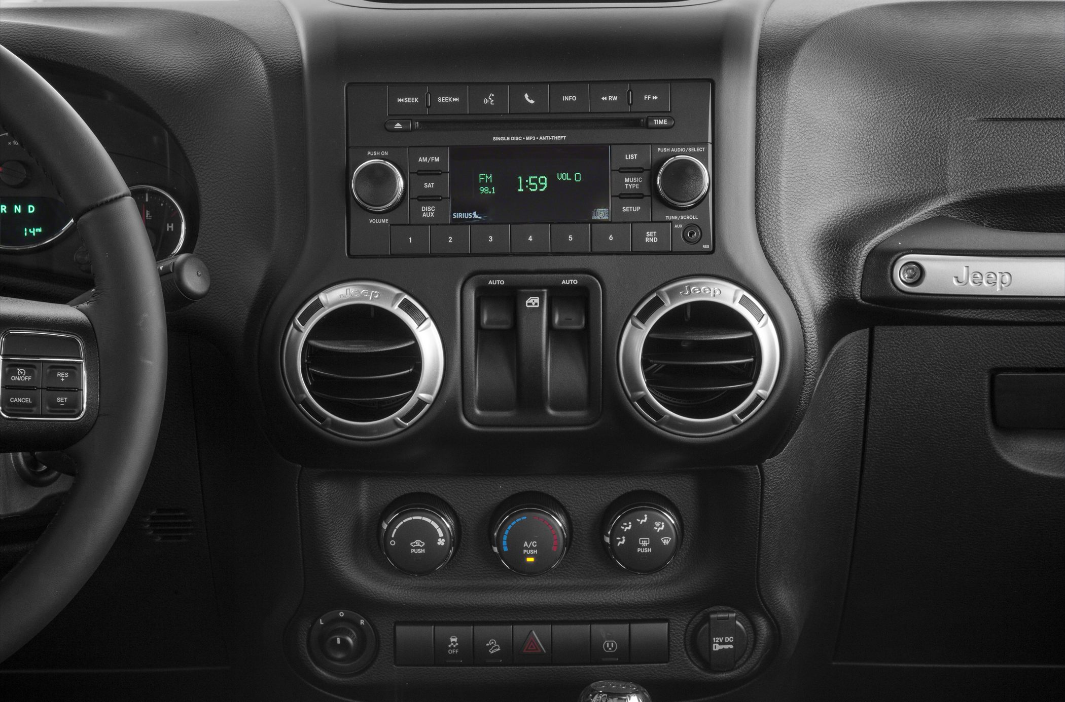 Dashboard center console with radio, air vents, climate controls, and steering wheel buttons.