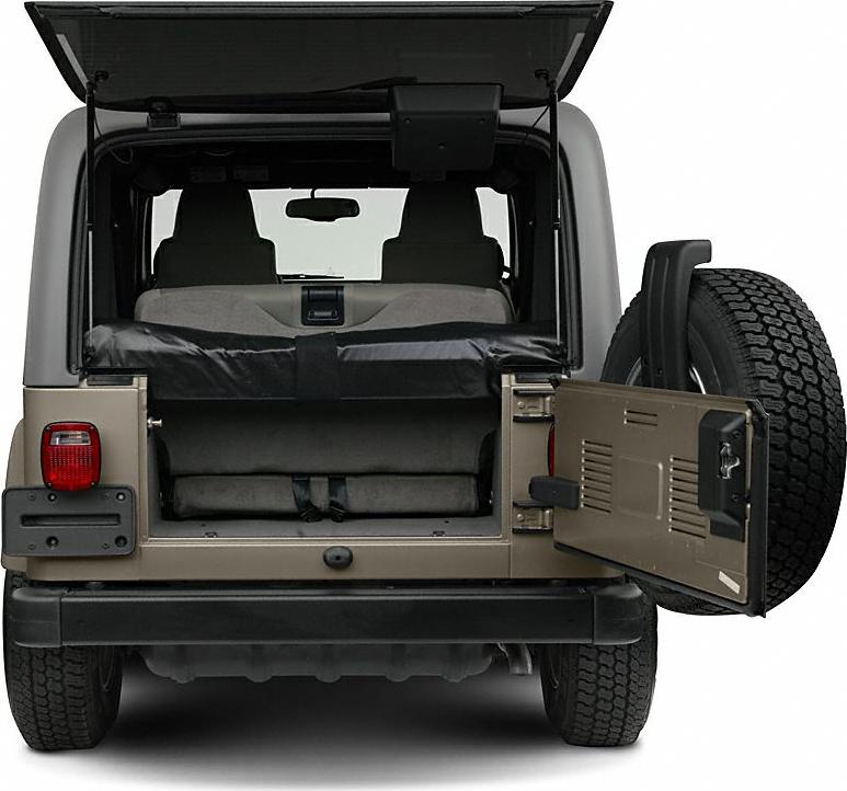 Rear cargo space with open tailgate and mounted spare tire