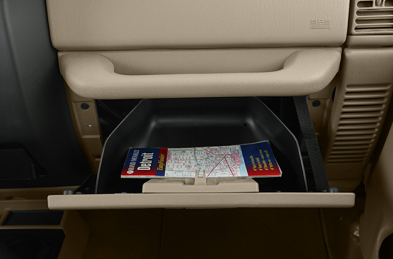 Open glove compartment with map inside beige interior