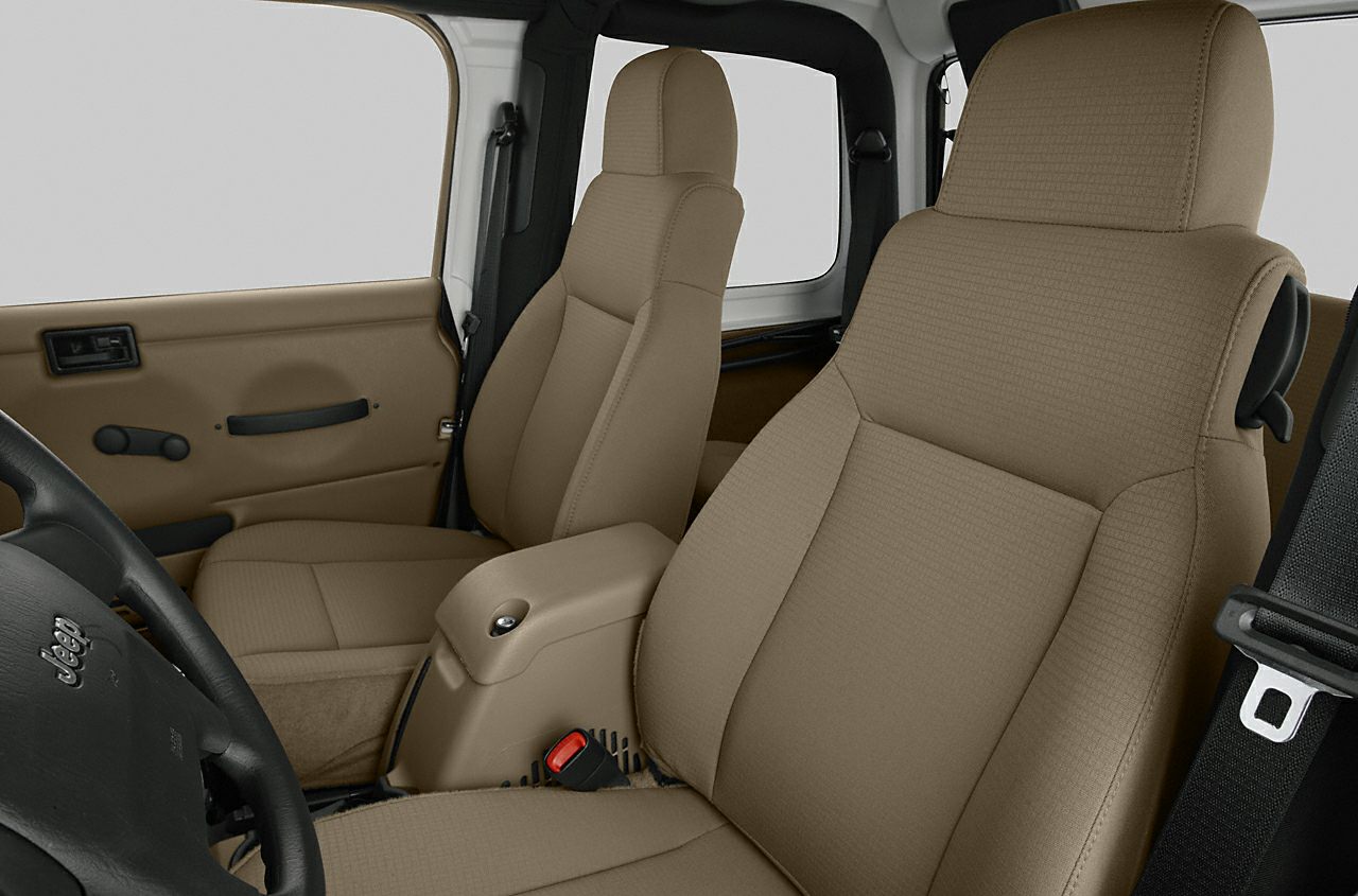 Beige front seats and door panel interior with armrest and seatbelt.