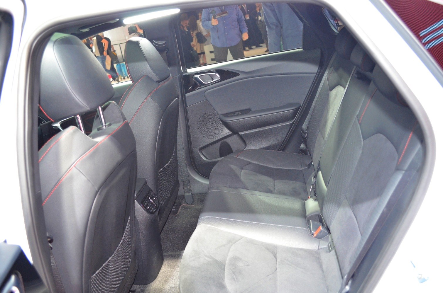 Rear seat interior with black upholstery and red stitching