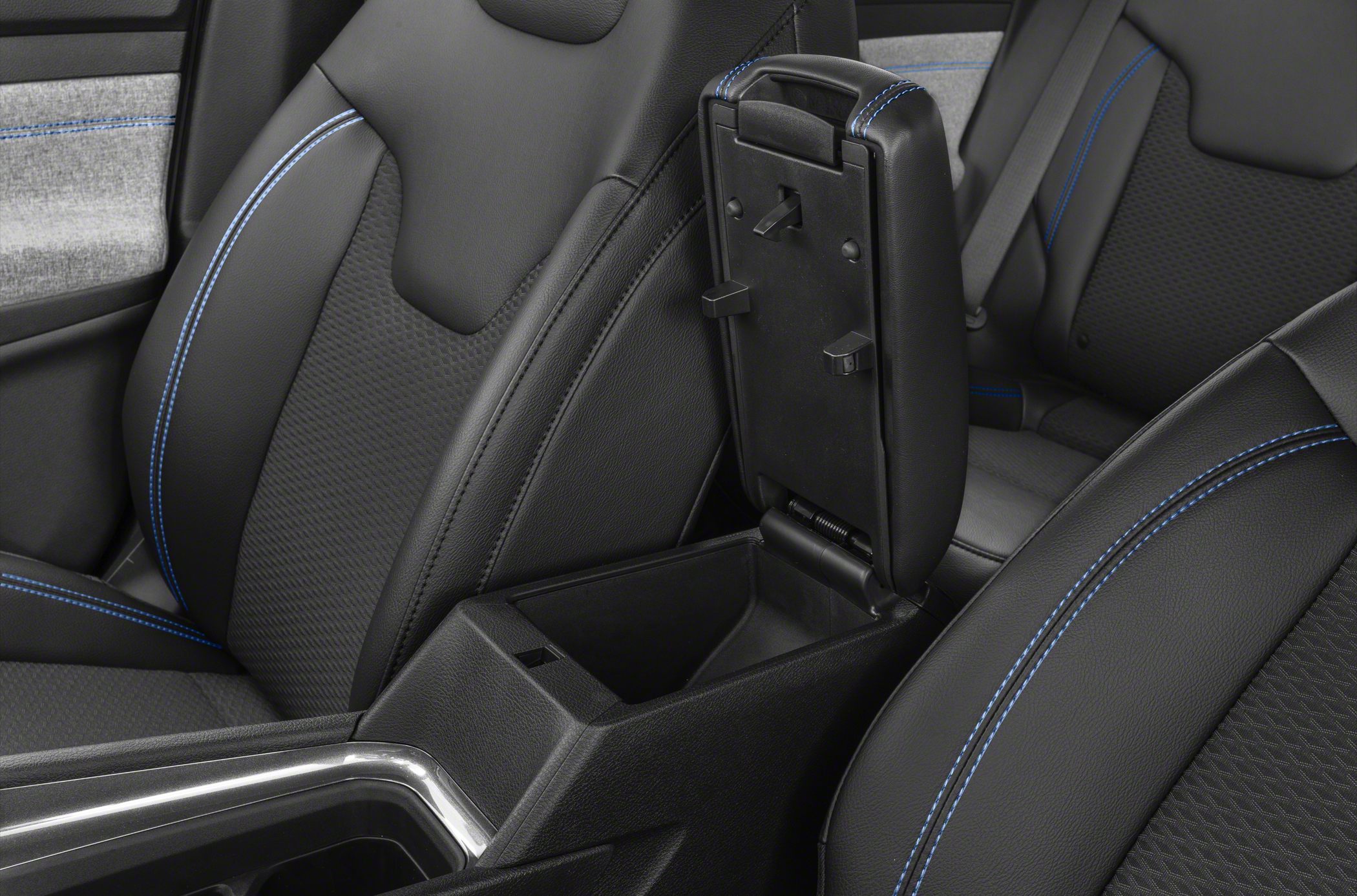 Open center console storage with black leather upholstery and blue stitching