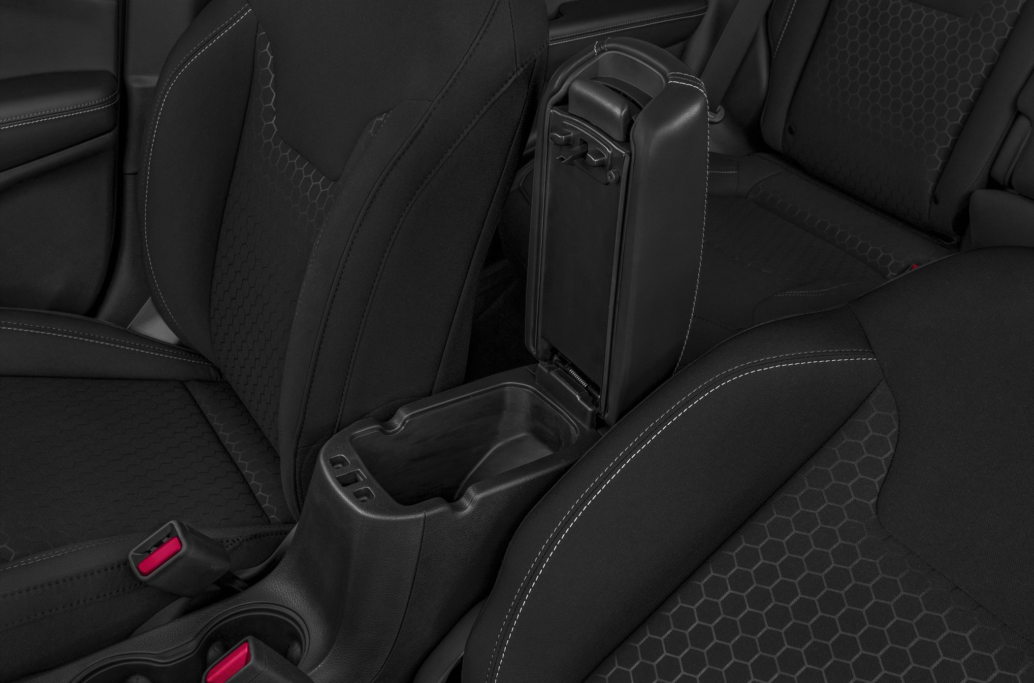 Center armrest storage and hexagonal pattern upholstery on seats