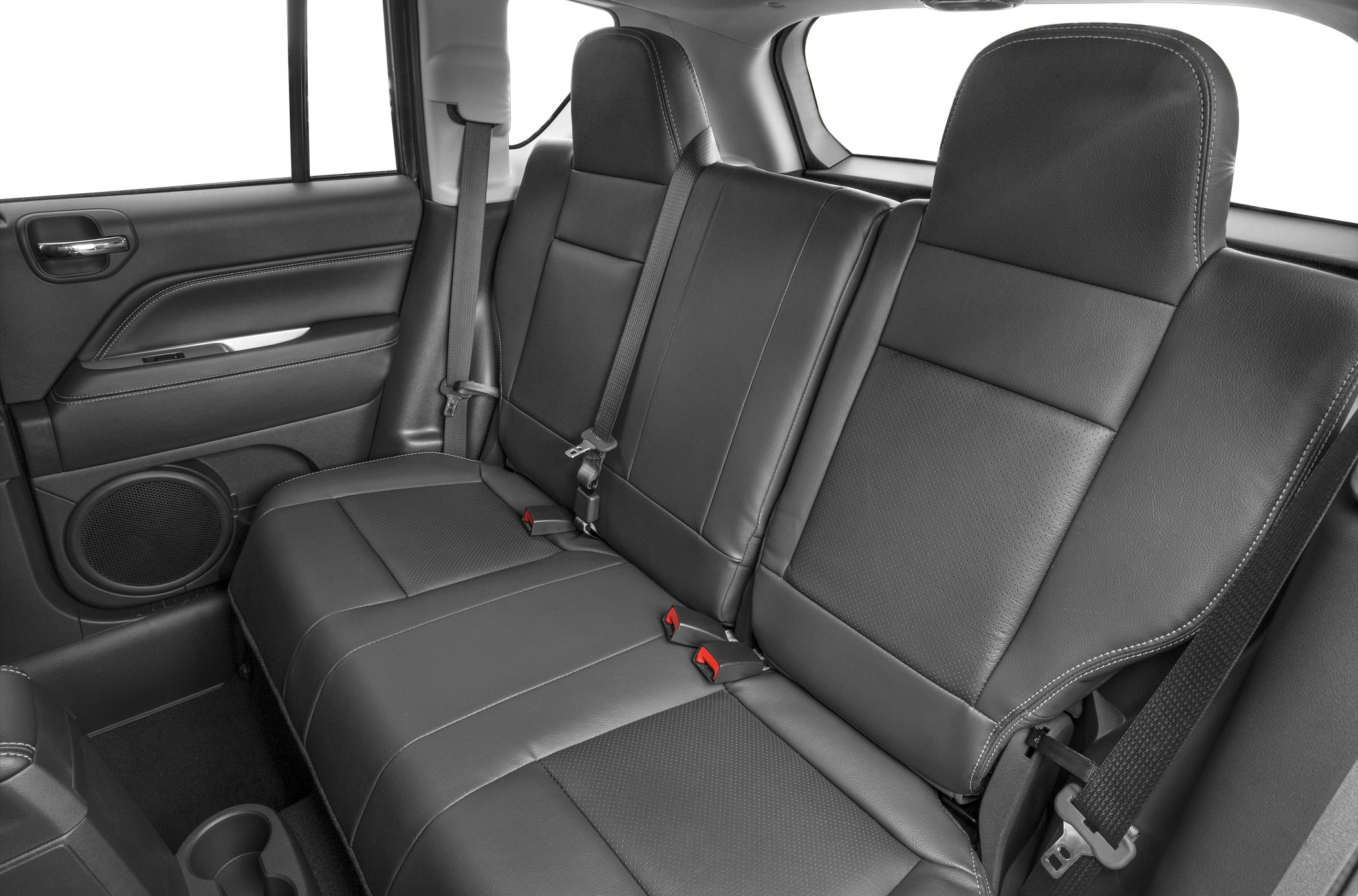 Black leather rear seats with seat belts and door panel.