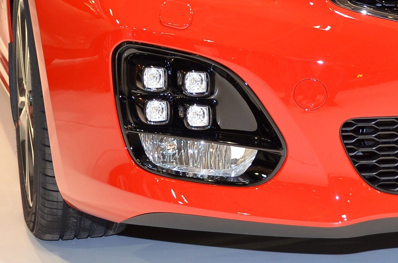 LED fog lights and front bumper detail on red car