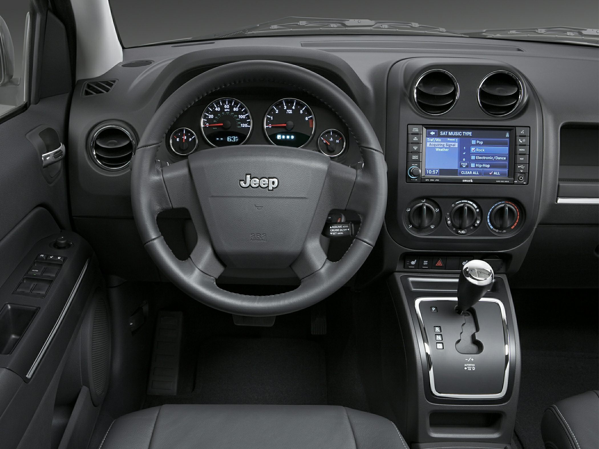 Steering wheel, dashboard with gauges, infotainment screen, and automatic gear shifter.
