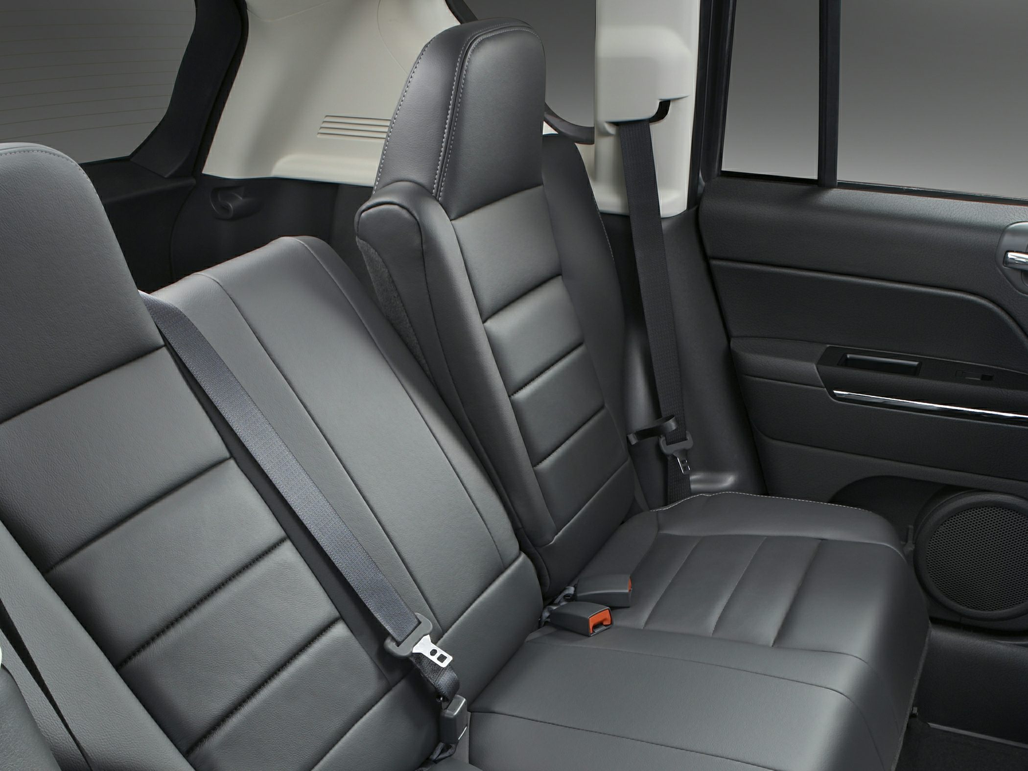 Rear seat interior with black leather upholstery and seatbelts