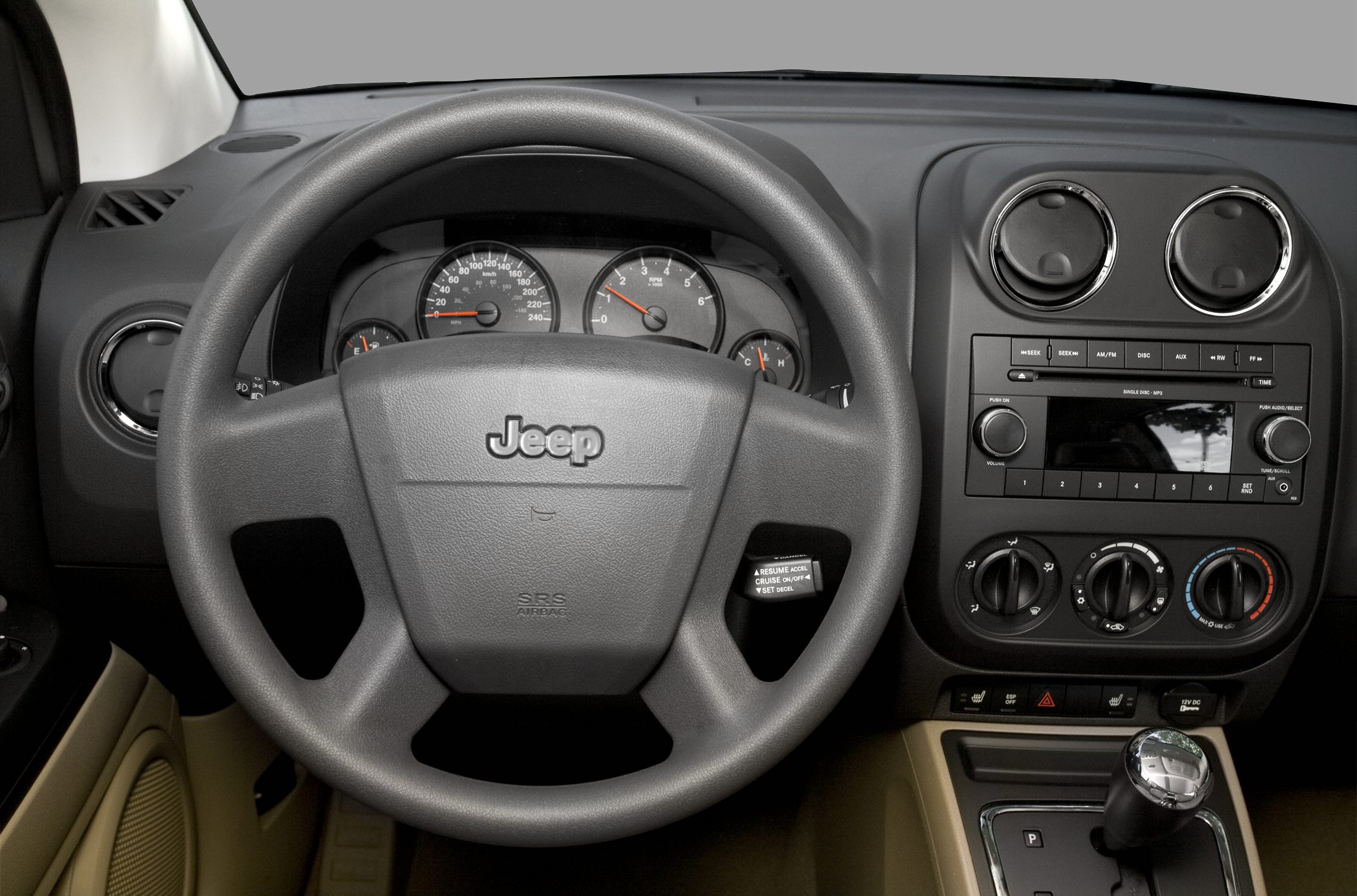 Steering wheel with Jeep logo and dashboard gauge cluster