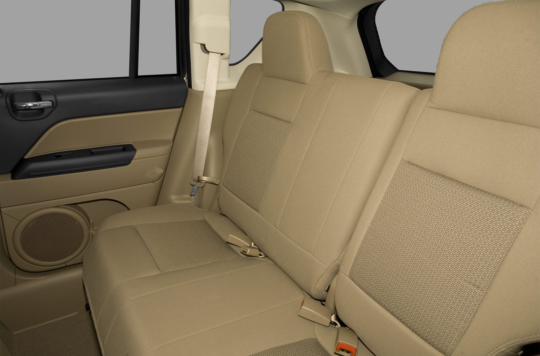 Beige fabric rear seat with safety belts and door panel speaker
