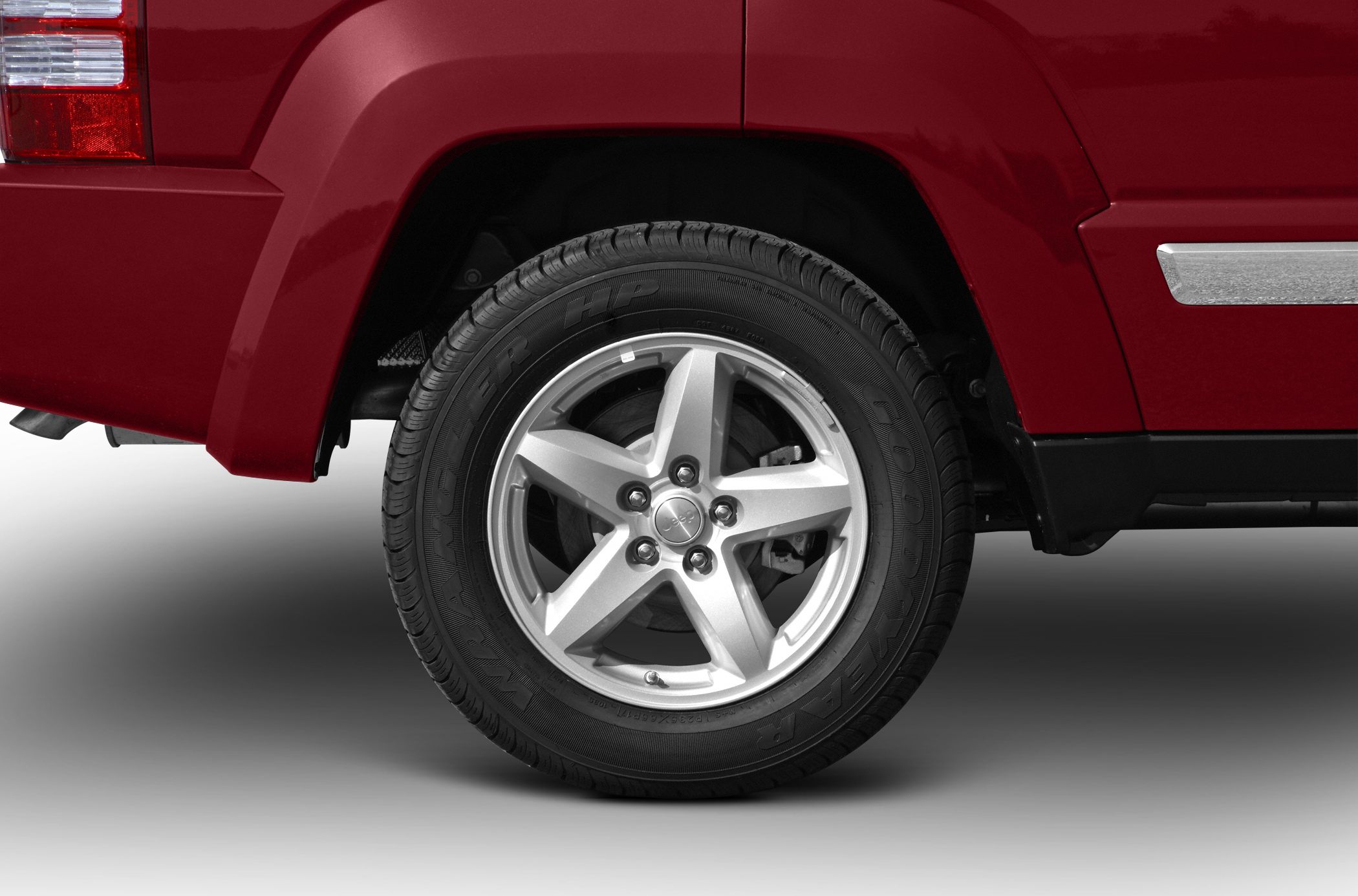 Five-spoke alloy wheel with Goodyear Wrangler HP tire on SUV.