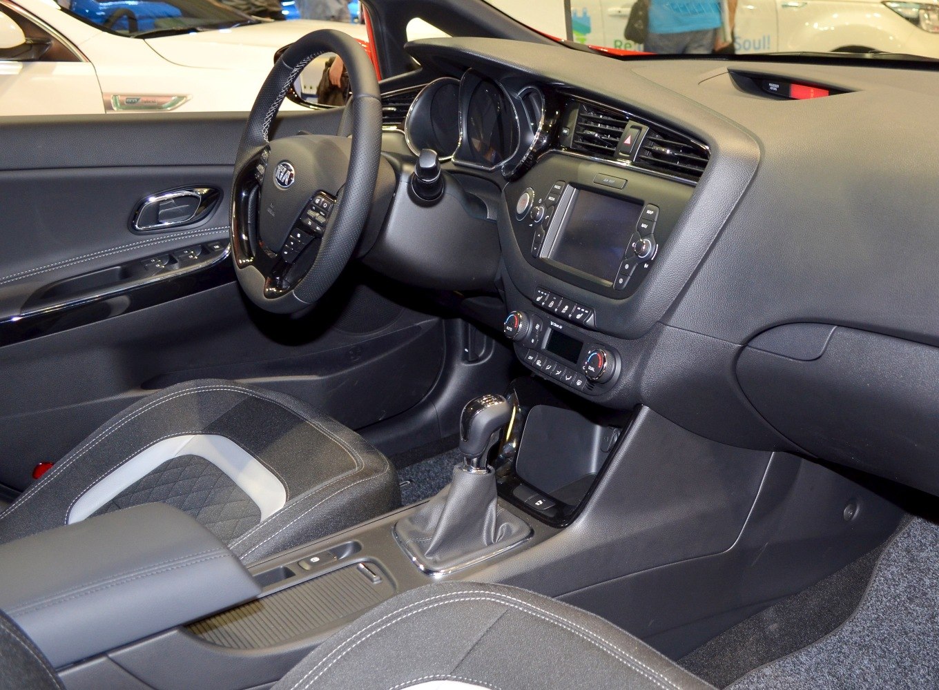 Modern car interior with dashboard, steering wheel, and gear shift