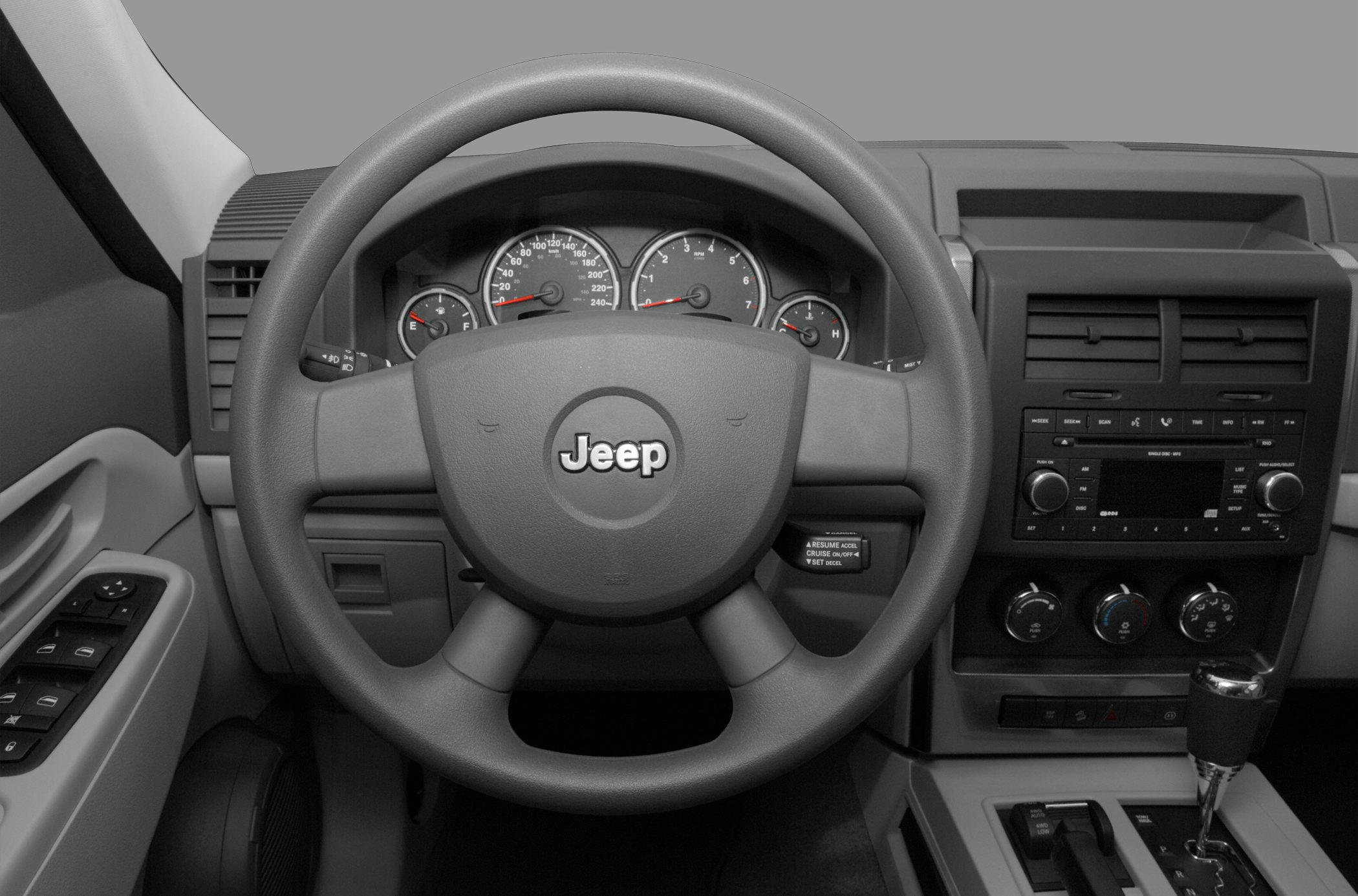 Dashboard with steering wheel, instrument cluster, radio, and gear shift