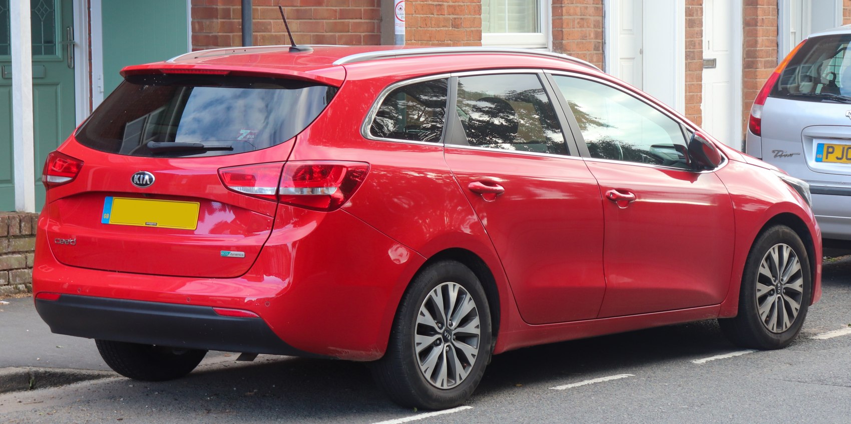 Red station wagon rear side with angular taillights and alloy wheels