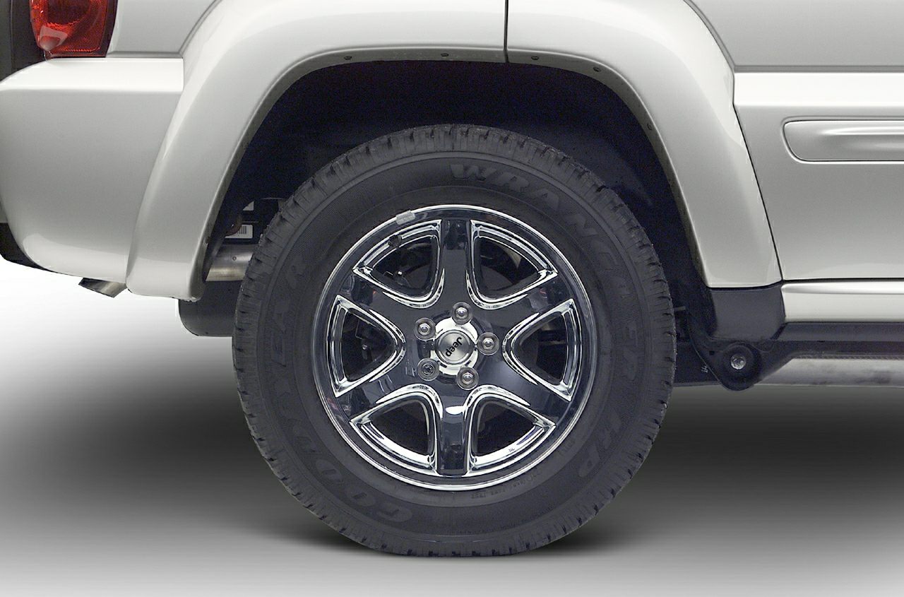 Chrome alloy wheel with Goodyear Wrangler tire on SUV rear side