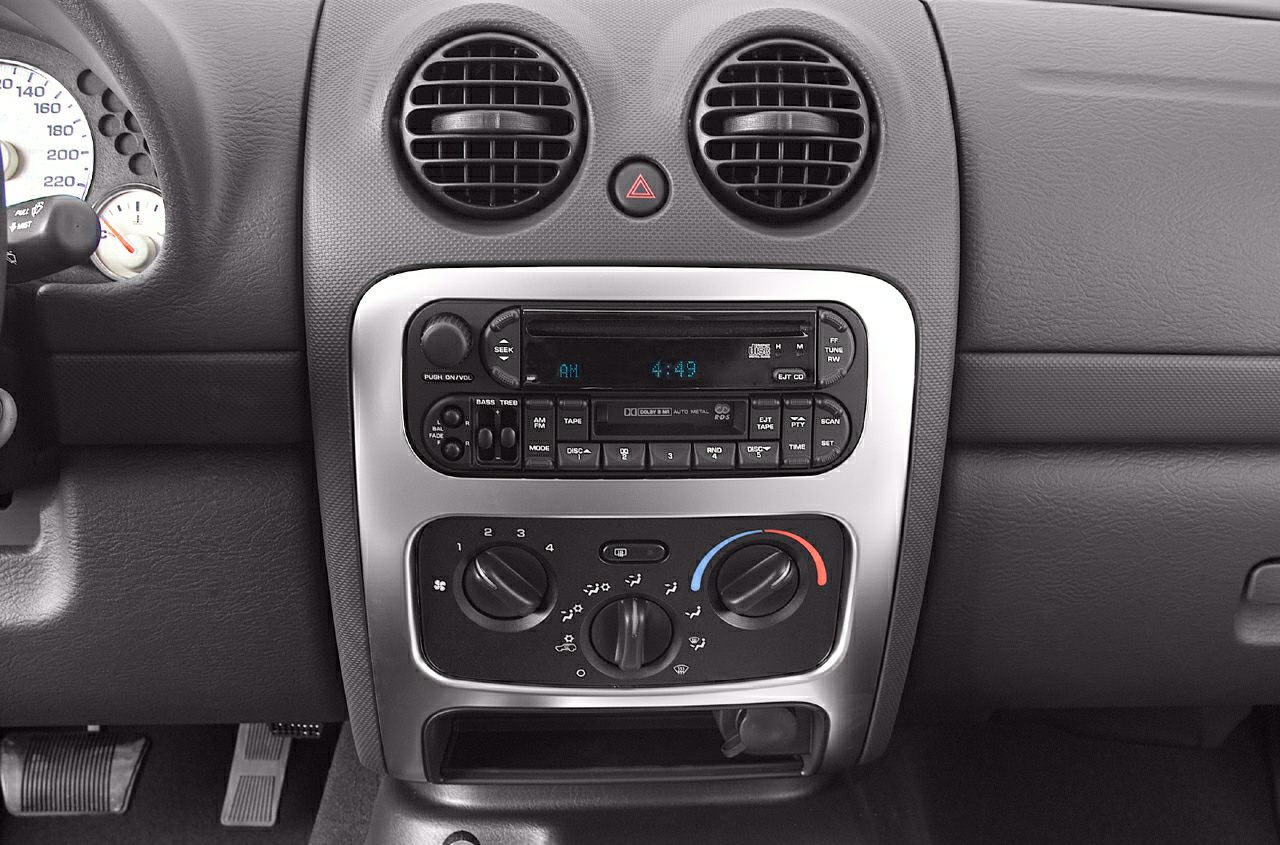 Dashboard center console with air vents, stereo, and climate controls