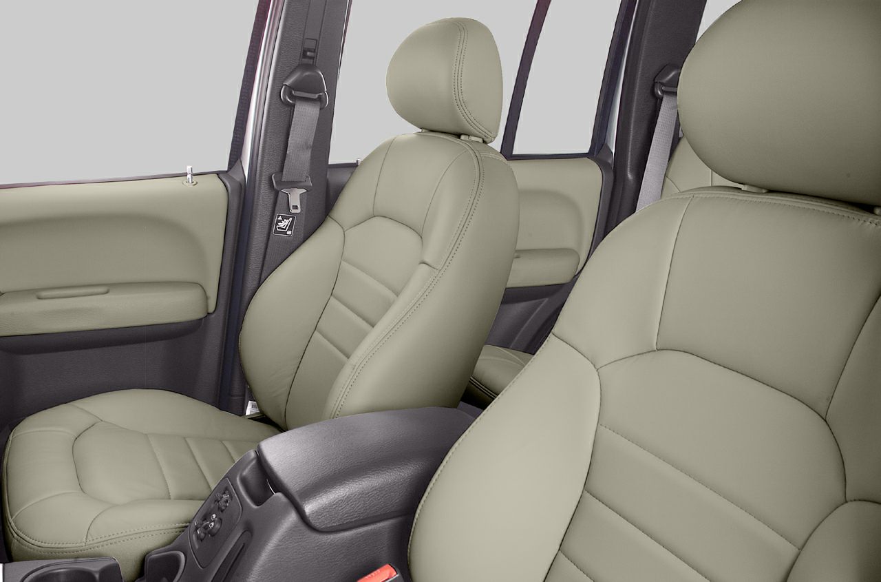 Beige leather front seats and part of interior door panels.