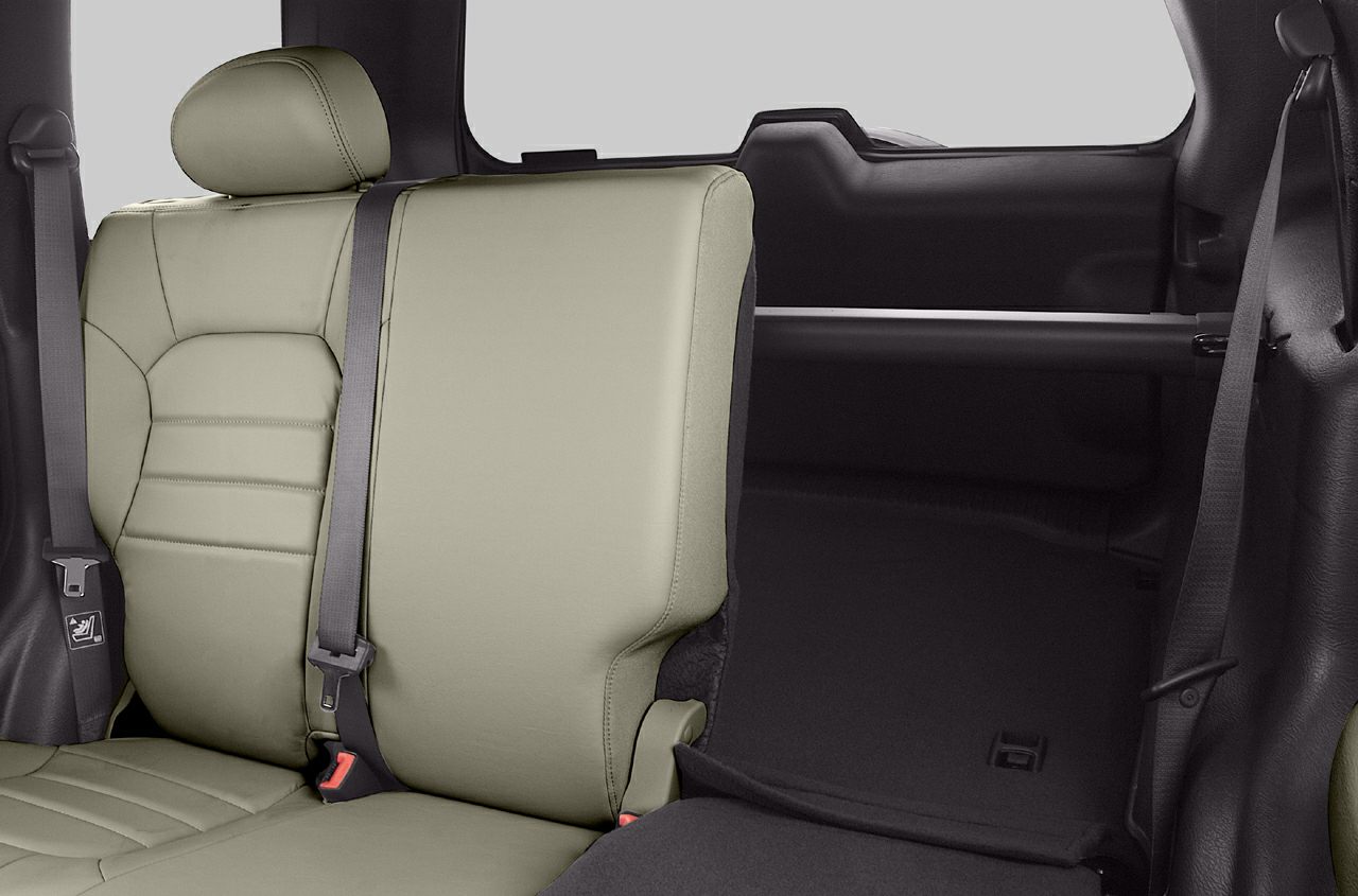 Rear seat interior with leather upholstery, seat belt, and headrest