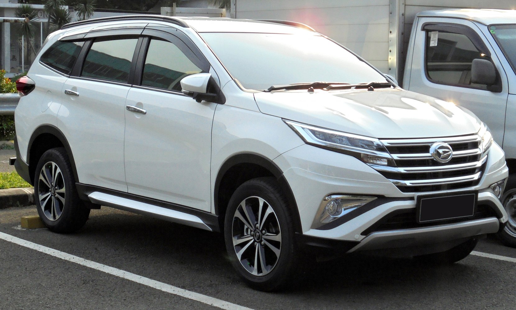 Front-side view of SUV with sleek headlights and alloy wheels
