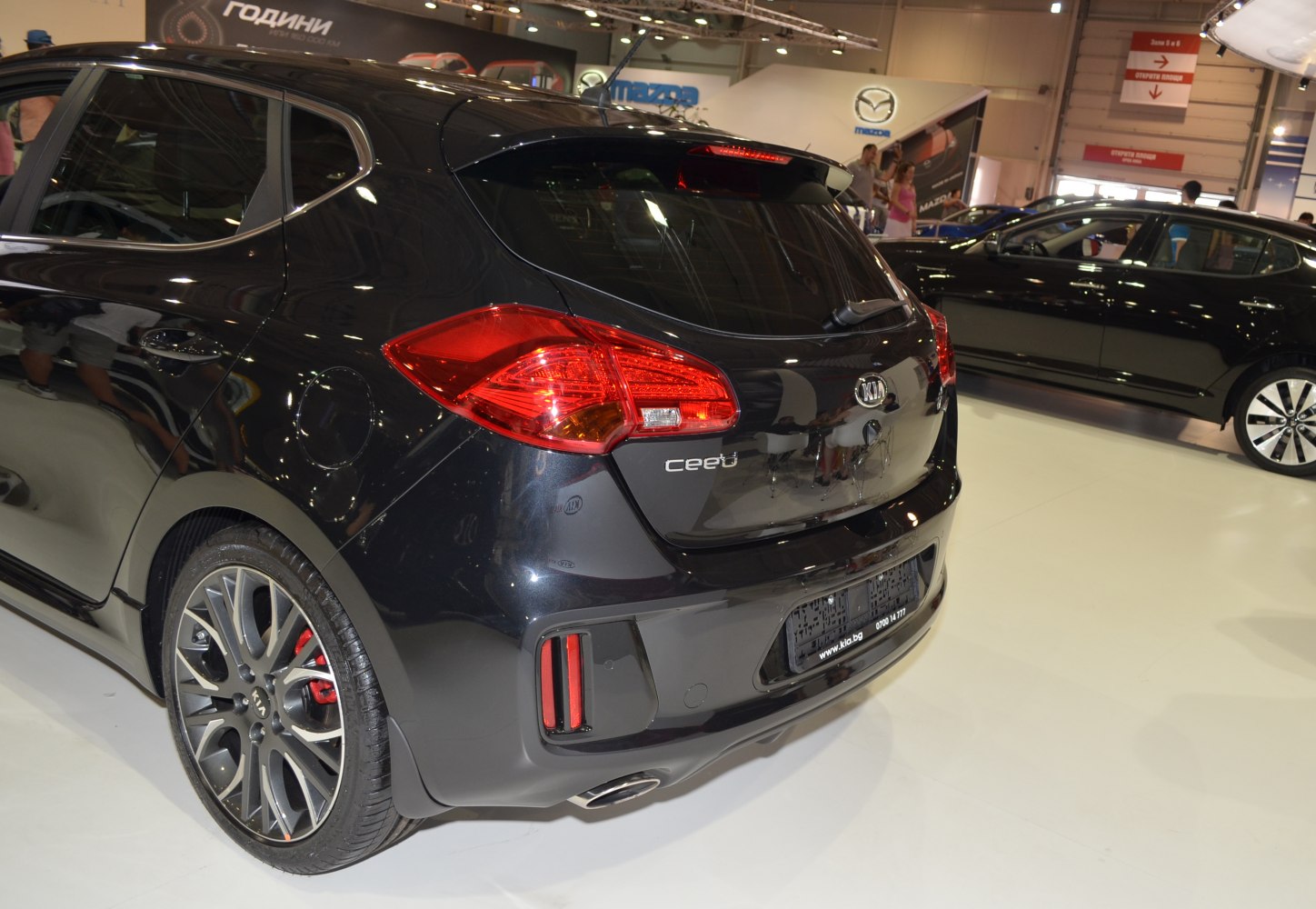Rear view of black hatchback with distinctive taillights and alloy wheels