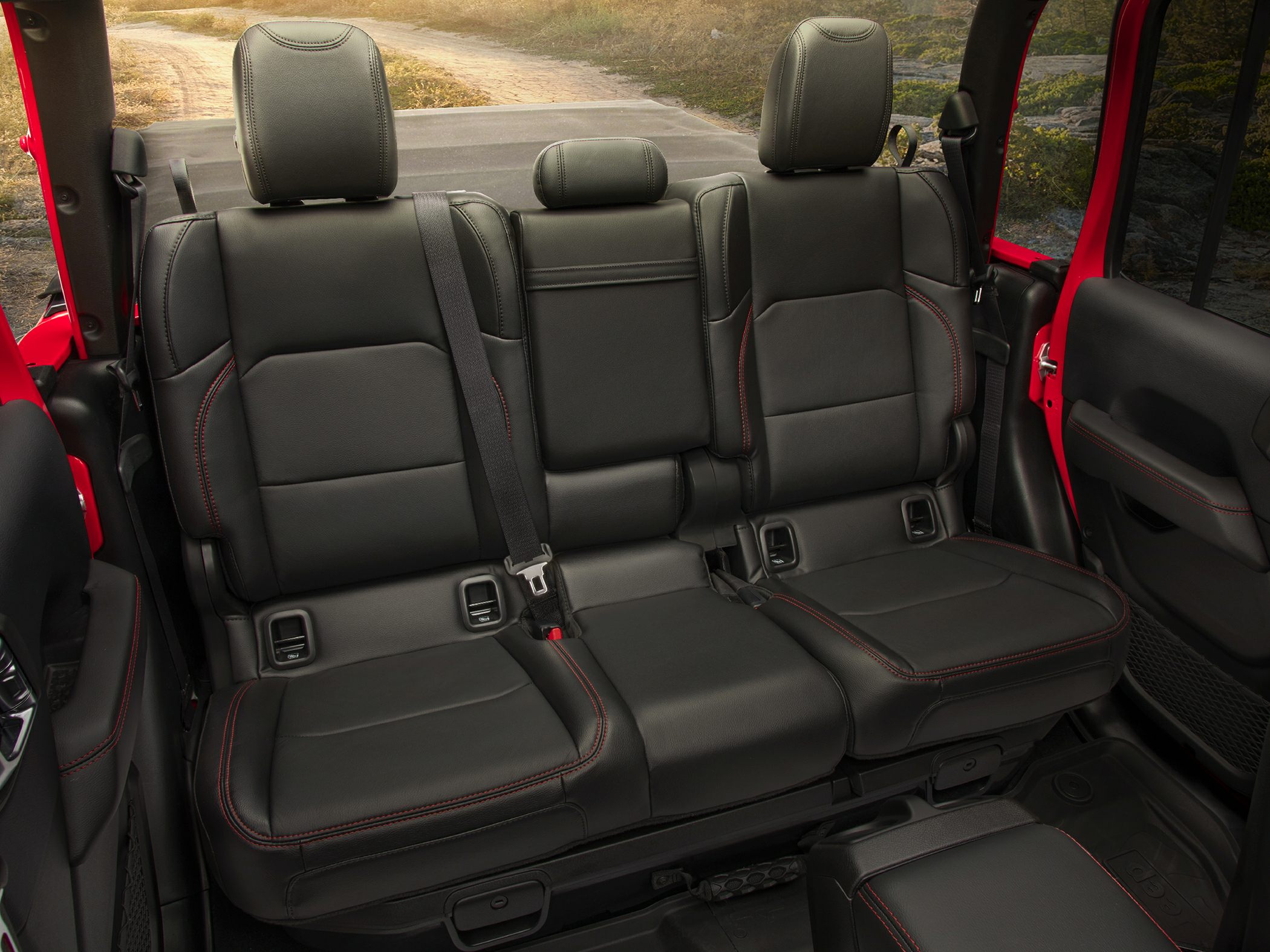 Rear leather seats with red stitching and adjustable headrests